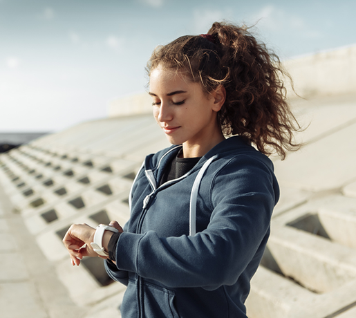 Woman exercising checking  smart watch