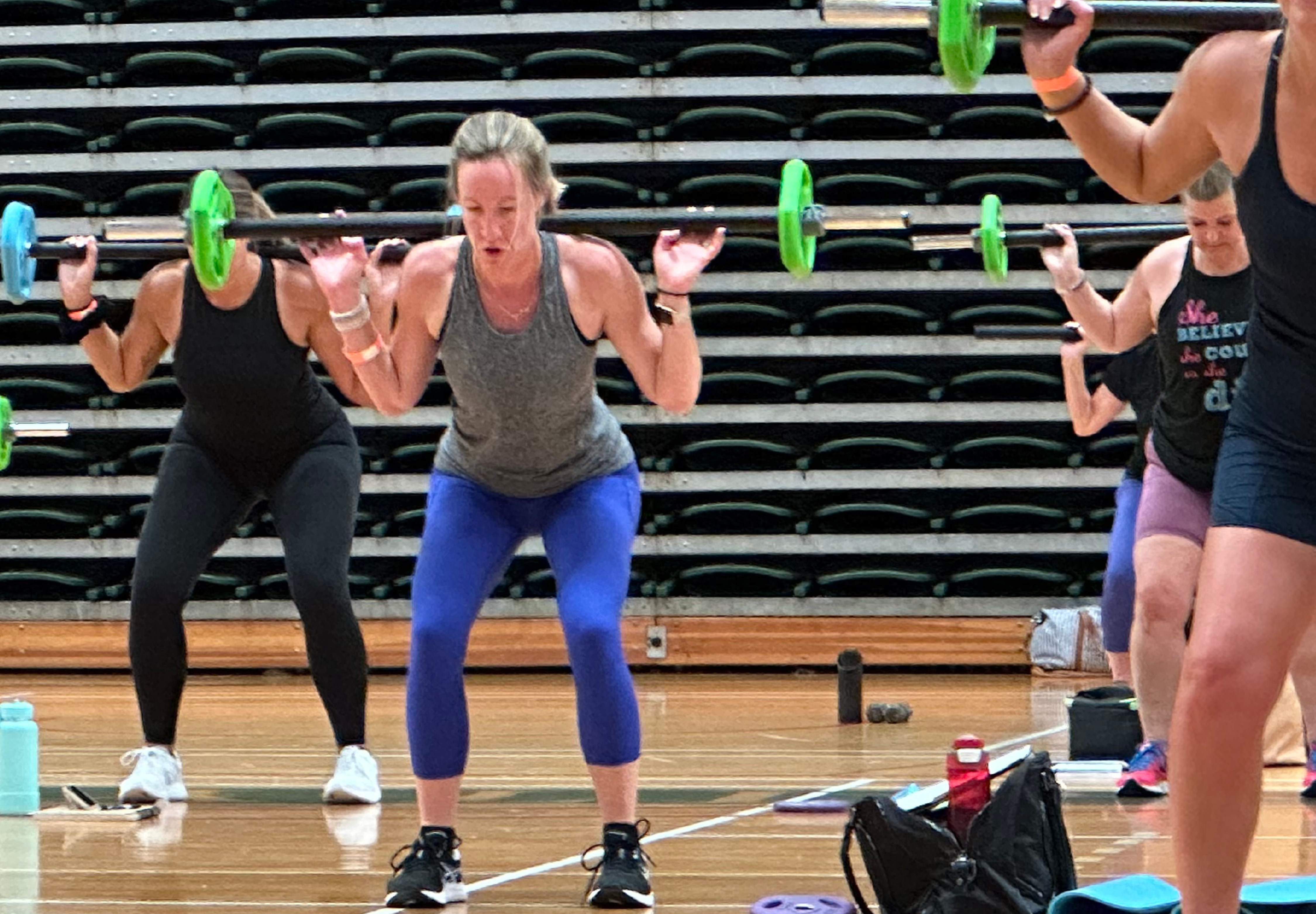 Image of group exercise class using barbells